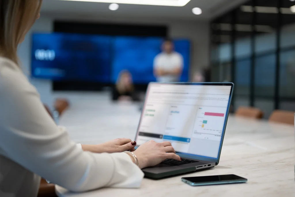 Person using a laptop to review a payment analytics dashboard during a business meeting