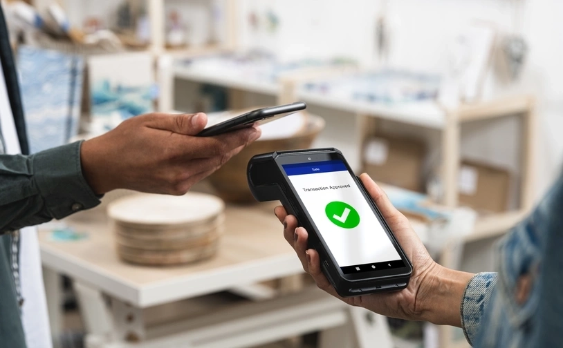 Customer using their phone to pay via contacless