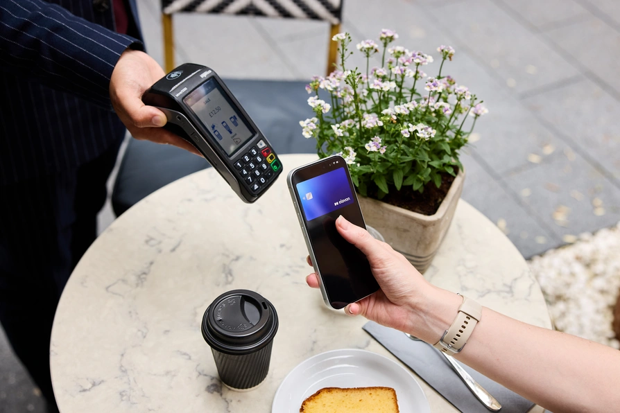 Digital wallet payment at a cafe table
